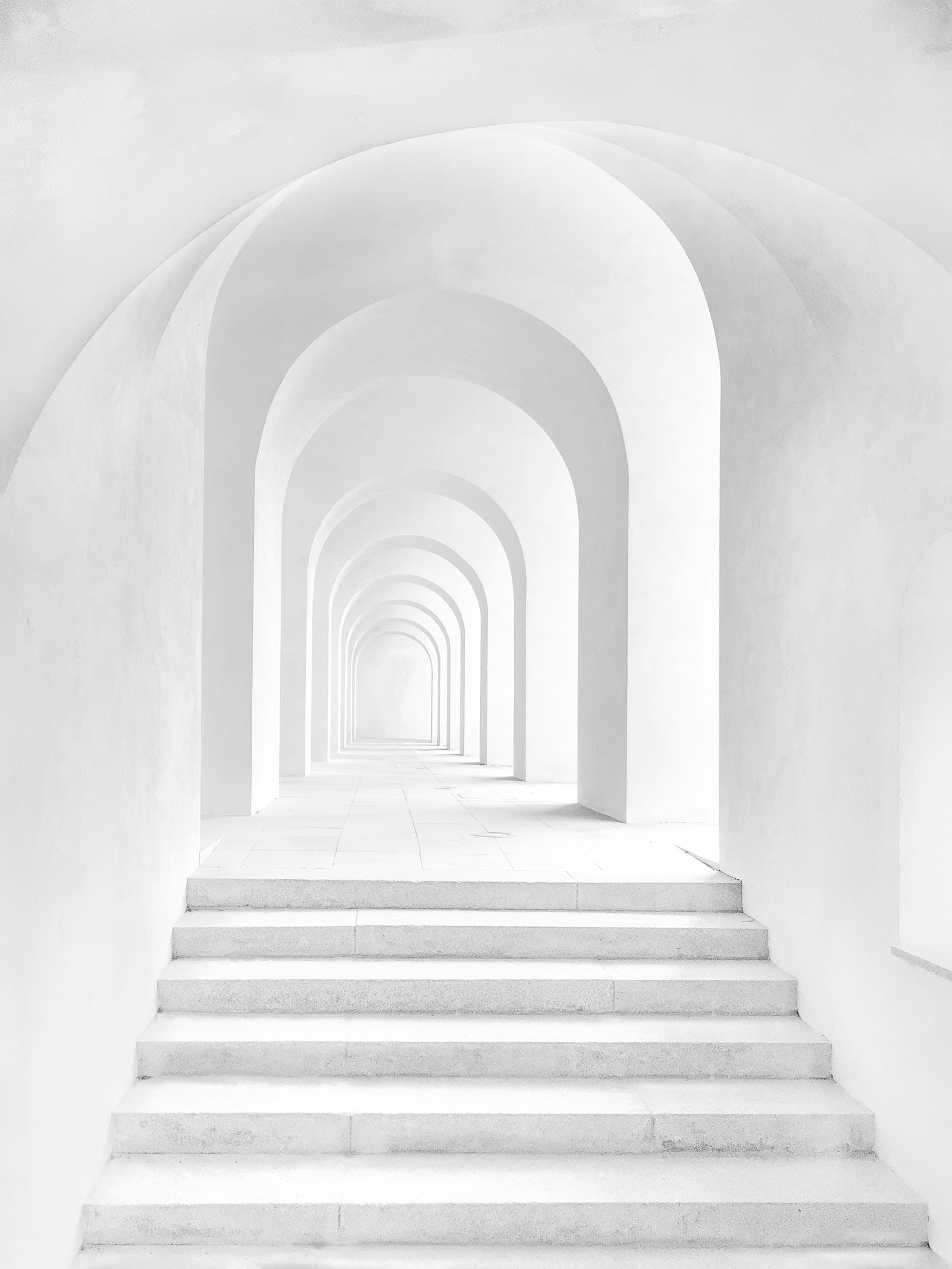 Minimalist white arched corridor