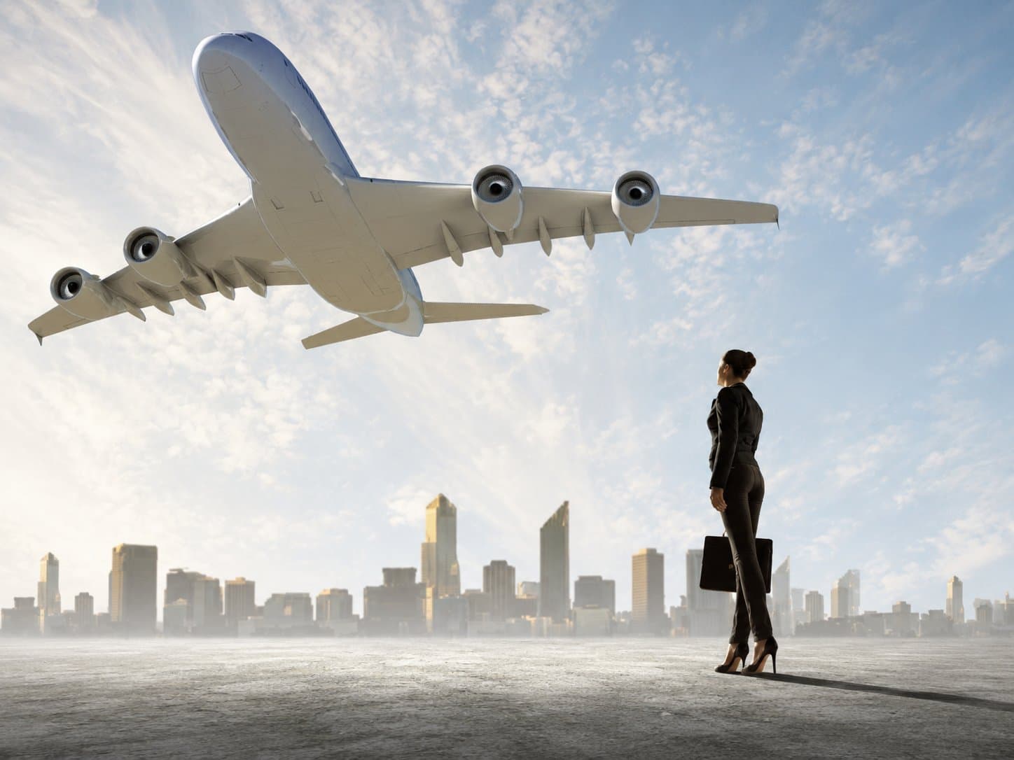 A traveller with a briefcase watching a widebody aircraft climb over a city skyline