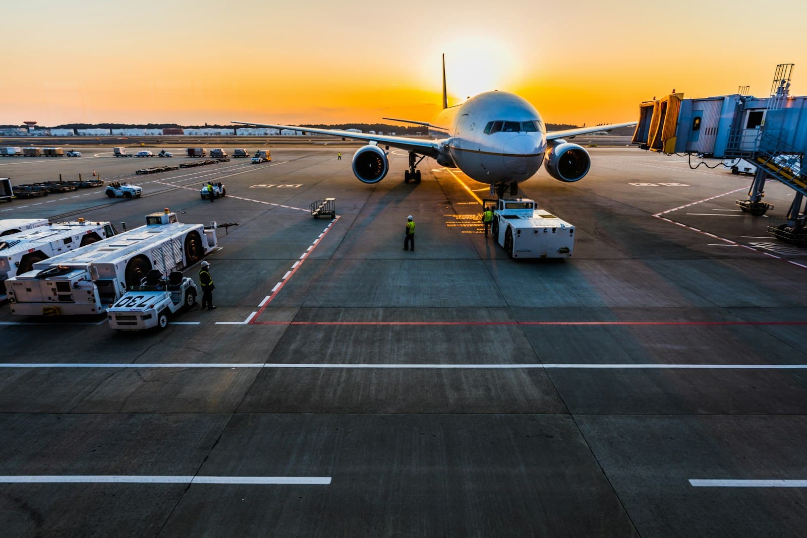 Aircraft at an airport gate at sunset