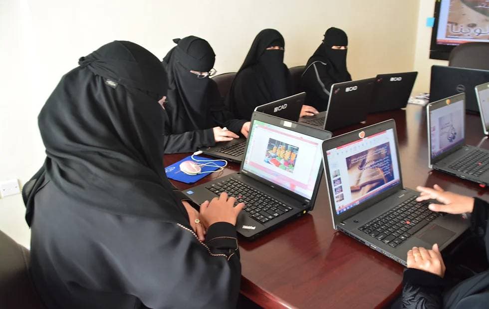 Participants in ICAD's Special Needs Ladies Program working at laptop workstations